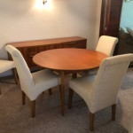 Wooden table with white chairs